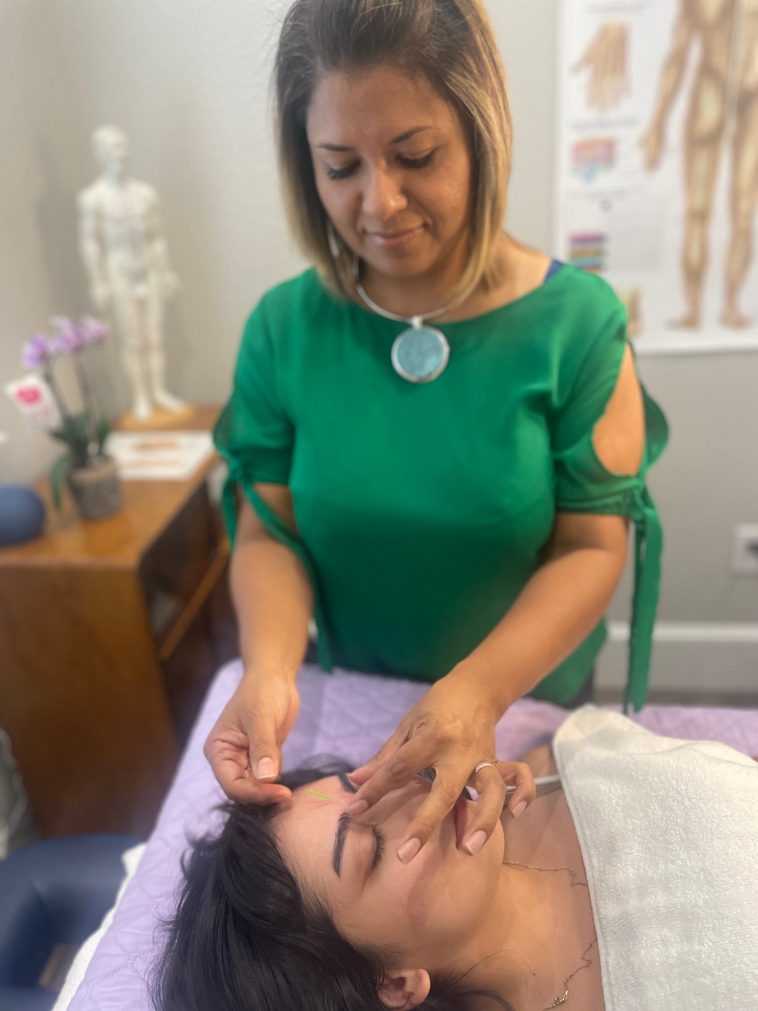 Patient getting TRADITIONAL CHINESE MEDICINE at Roots of Health
